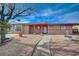 Single story home with rock landscaping, mature trees, and a curved sidewalk at 1113 Date St, Las Vegas, NV 89108