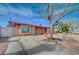 Single story home with rock landscaping, and a mature tree in the front yard at 1113 Date St, Las Vegas, NV 89108