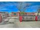 Single story home with a driveway behind a fence and a beautiful blue sky at 1113 Date St, Las Vegas, NV 89108