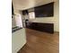 Bright kitchen features wood-look flooring, dark cabinets, and a white gas range at 1113 Date St, Las Vegas, NV 89108