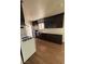 Bright kitchen features wood-look flooring, dark cabinets, and a white gas range at 1113 Date St, Las Vegas, NV 89108