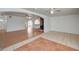 Spacious living room featuring tile and wood laminate flooring with arched doorways and ceiling fans at 1113 Date St, Las Vegas, NV 89108