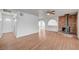 Cozy living room with wood laminate flooring, arched doorways, and a red brick fireplace at 1113 Date St, Las Vegas, NV 89108