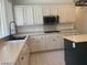 Spacious kitchen with white cabinets and stainless steel appliances at 1297 Peppercorn Ave, Henderson, NV 89012