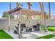 Comfortable backyard with a shaded seating area and lush artificial grass at 139 Serenade Ct, Henderson, NV 89074