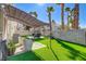 Relaxing backyard featuring an outdoor lounge area and artificial turf at 139 Serenade Ct, Henderson, NV 89074