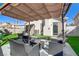 Outdoor patio area with a shaded structure, outdoor seating, and manicured landscaping at 139 Serenade Ct, Henderson, NV 89074