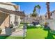 Lush backyard featuring artificial grass, lounge furniture, and a shaded pergola for outdoor relaxation at 139 Serenade Ct, Henderson, NV 89074
