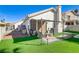 Manicured backyard with artificial turf, a patio, and well-maintained landscaping at 139 Serenade Ct, Henderson, NV 89074