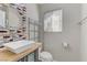 Stylish bathroom featuring a vessel sink, decorative mirror, and modern shelving at 139 Serenade Ct, Henderson, NV 89074