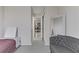 Neutral-toned bedroom featuring a sofa, bed, and an open doorway at 139 Serenade Ct, Henderson, NV 89074