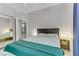 Comfortable bedroom with a queen bed, side tables and view of ensuite bathroom and closet through mirror at 139 Serenade Ct, Henderson, NV 89074