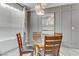 Elegant dining area with a glass-top table, comfortable chairs, and contemporary lighting at 139 Serenade Ct, Henderson, NV 89074