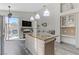 Modern kitchen with island, stainless steel appliances, fireplace, and sliding door to outdoor living space at 139 Serenade Ct, Henderson, NV 89074