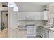 Well-lit kitchen with white appliances, ample cabinet space, and a convenient kitchen island at 139 Serenade Ct, Henderson, NV 89074