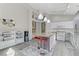 Bright kitchen showcasing white cabinets, an island with seating, and modern lighting at 139 Serenade Ct, Henderson, NV 89074