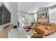 Spacious living room featuring a comfortable couch, sleek TV console, and modern decor at 139 Serenade Ct, Henderson, NV 89074