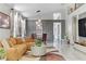 Bright living room featuring a comfortable sectional couch, modern lighting, and stylish decor at 139 Serenade Ct, Henderson, NV 89074