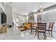 Open-concept living space featuring dining area, a comfortable sectional couch, and sleek modern decor at 139 Serenade Ct, Henderson, NV 89074