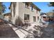 Exterior view of a multi-story home with a basketball hoop and a dirt area at 1457 Summer Glow Ave, Henderson, NV 89012