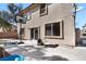 Exterior view of a multi-story home with a concrete patio and a basketball hoop at 1457 Summer Glow Ave, Henderson, NV 89012