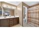 Neutral toned bathroom featuring a double sink vanity and shower with patterned curtain at 1457 Summer Glow Ave, Henderson, NV 89012