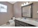 This bathroom includes a single sink vanity with a white countertop and dark cabinets at 1457 Summer Glow Ave, Henderson, NV 89012