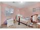 This is a pink bedroom with a large window and white furniture at 1457 Summer Glow Ave, Henderson, NV 89012