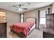 Comfortable bedroom with neutral carpet, windows with blinds, and a ceiling fan at 1457 Summer Glow Ave, Henderson, NV 89012