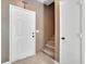 Inviting entryway with a white door and neutral-toned walls leading to carpeted stairs at 1457 Summer Glow Ave, Henderson, NV 89012