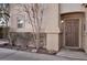 A brown front door with side garden, walkway, and outdoor light fixture at 1457 Summer Glow Ave, Henderson, NV 89012
