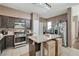 Modern kitchen with stainless steel appliances, a center island, and mosaic backsplash at 1457 Summer Glow Ave, Henderson, NV 89012