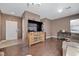 Open living area with hard floors, complemented by a large TV and wooden furniture at 1457 Summer Glow Ave, Henderson, NV 89012