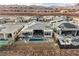 Aerial view of a neighborhood with a luxury home featuring a pool, patio, and solar panels at 148 Tre Pietre St, Henderson, NV 89011