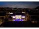 Night aerial view showing the backyard and pool lit up with bright blue lights at 148 Tre Pietre St, Henderson, NV 89011