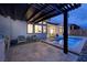 Backyard patio features a pool, outdoor kitchen, and ample seating for relaxing in the sun at 148 Tre Pietre St, Henderson, NV 89011