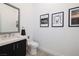 Stylish powder room featuring a modern vanity with sleek fixtures and tasteful wall decor at 148 Tre Pietre St, Henderson, NV 89011