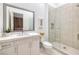 Modern bathroom featuring a glass-enclosed shower, tiled walls, large mirror, and floating vanity at 148 Tre Pietre St, Henderson, NV 89011