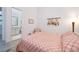Bedroom features a view of a clean and bright ensuite bathroom with simple framed art and neutral tones at 148 Tre Pietre St, Henderson, NV 89011