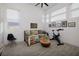 Multi-purpose spare room with comfortable daybed, exercise bike, wood accent furniture and bright natural light at 148 Tre Pietre St, Henderson, NV 89011