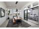 Dining room with modern lighting, expansive windows, and a sliding glass door to an outdoor space with seating at 148 Tre Pietre St, Henderson, NV 89011
