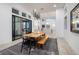 Bright dining area featuring modern lighting, a wooden table set, and expansive windows at 148 Tre Pietre St, Henderson, NV 89011