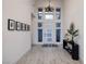 Bright, soaring foyer with eye-catching light fixture and views to the exterior at 148 Tre Pietre St, Henderson, NV 89011