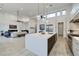 Spacious kitchen with a waterfall island, pendant lights, and open to the living room, perfect for entertaining at 148 Tre Pietre St, Henderson, NV 89011