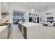A bright kitchen is adjacent to a living room and dining room, with high ceilings and access to an outdoor space at 148 Tre Pietre St, Henderson, NV 89011