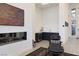 Modern living room with a fireplace, wet bar and stylish decor with high ceilings at 148 Tre Pietre St, Henderson, NV 89011
