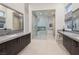 Upscale bathroom with dual vanities, glass-enclosed shower, and a freestanding tub for a spa-like experience at 148 Tre Pietre St, Henderson, NV 89011