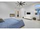 Stylish bedroom with a fireplace, TV, and seating area; bright and airy at 148 Tre Pietre St, Henderson, NV 89011
