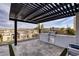 Outdoor kitchen with built in grill and pergola covering, great for entertaining guests with amazing views at 148 Tre Pietre St, Henderson, NV 89011