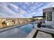 Backyard with a luxurious pool and spa with an outdoor kitchen, providing a perfect space for relaxation and entertainment at 148 Tre Pietre St, Henderson, NV 89011